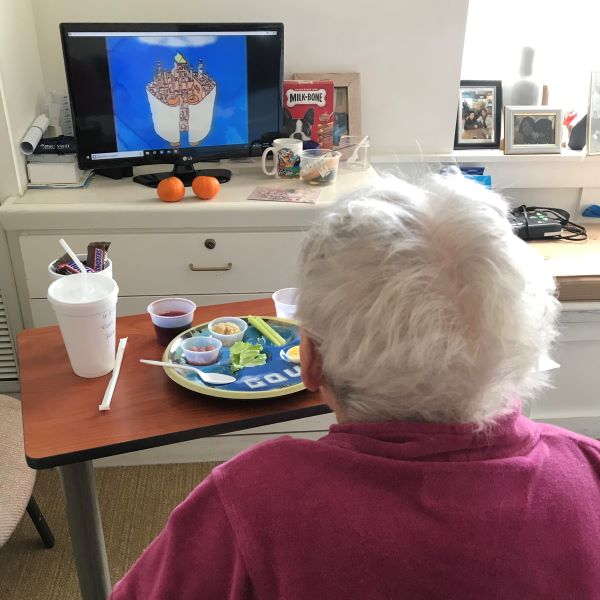 Senior Ruth eating and watching tv