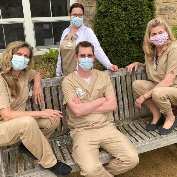 Caregiving team in tan scrubs