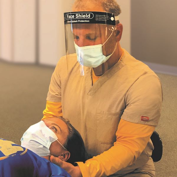 Scott Rosen working on a patient