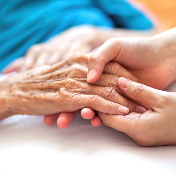 Holding a senior's hands